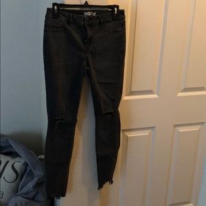 Black ripped jeans with frayed bottoms